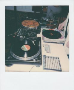 Vintage DJ setup featuring vinyl records and turntables, evoking nostalgia and retro vibes.